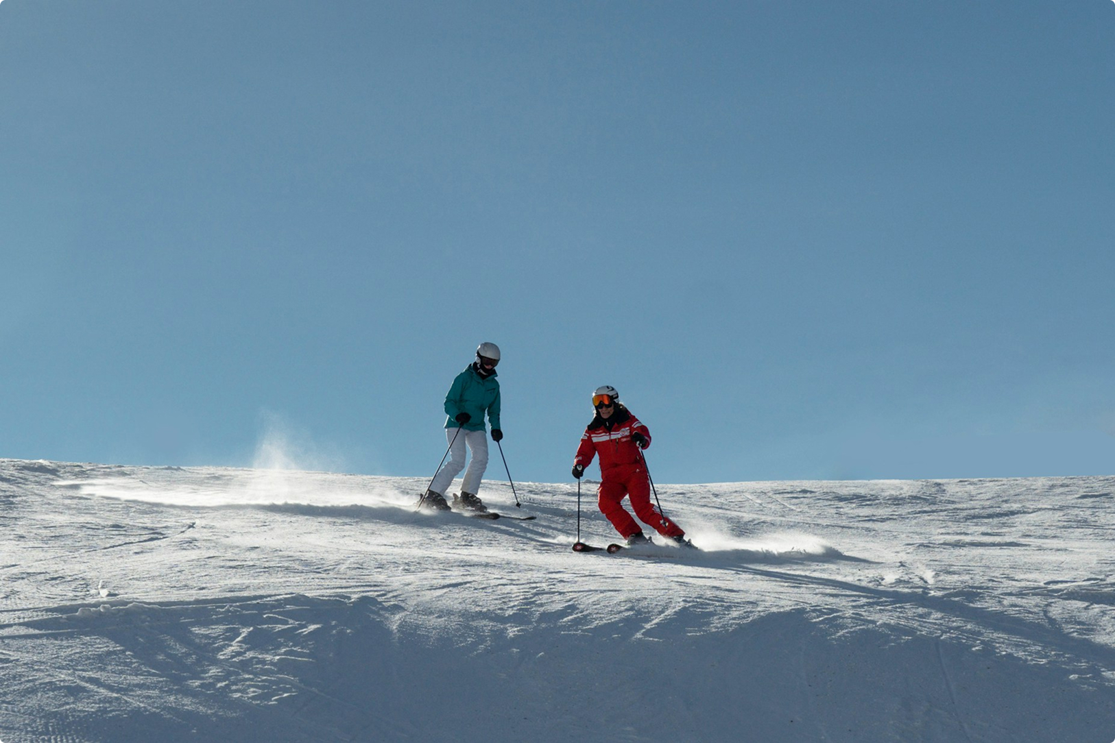 People Skiing Down A Mountain