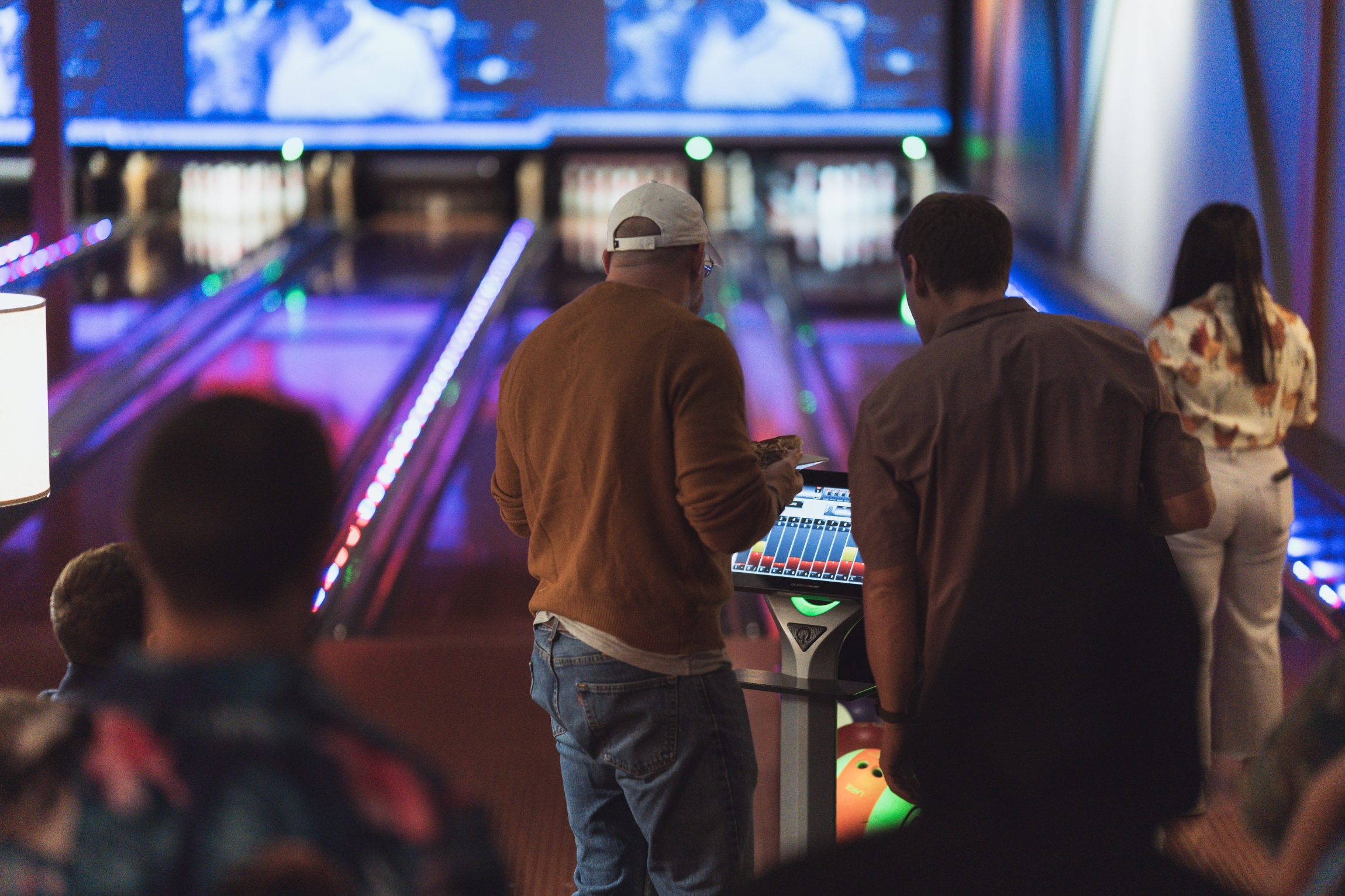 People bowling and marking their scores