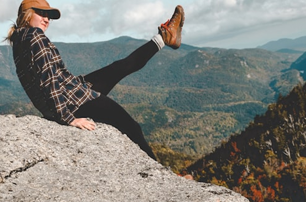 Female Hiker Sitting On The Top Of The Summit