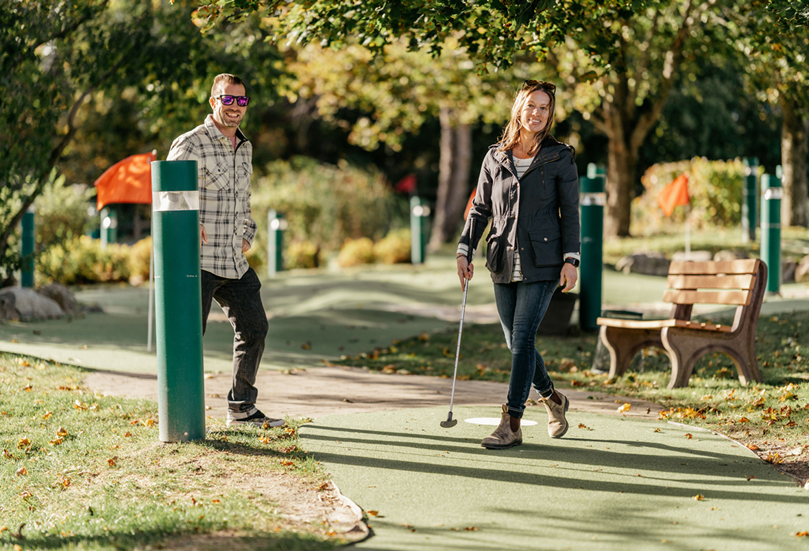 Couple Playing Mini Golf